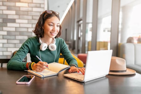 woman at laptop considering different blog post types for the content she's creating