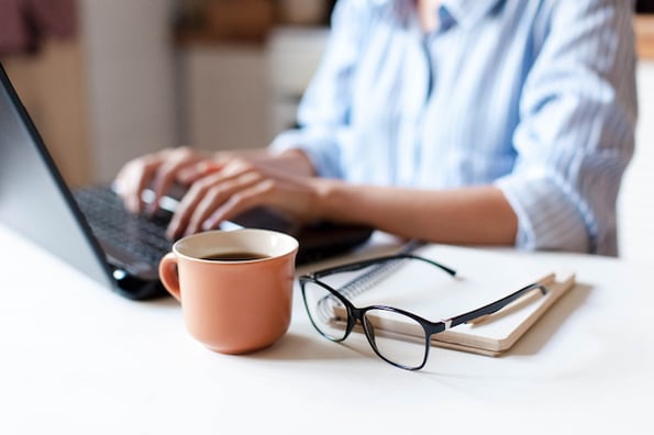 need for business plan Marketer typing up a business plan on their laptop