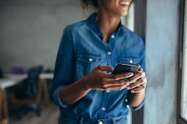 woman using a mobile phone with a mobile WordPress app