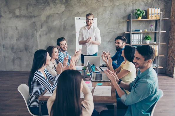 a group of people sitting around a table discussing how to create a membership site using WordPress