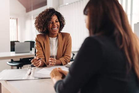 Sales person upselling and cross-selling a loyal customer to solve their needs
