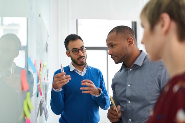 Customer service managers discussing customer experience design and strategy best practices