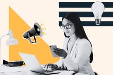 customer experience strategy: image shows a customer service representative sitting at their desk with a phone in hand and computer open reading feedback from customers. 