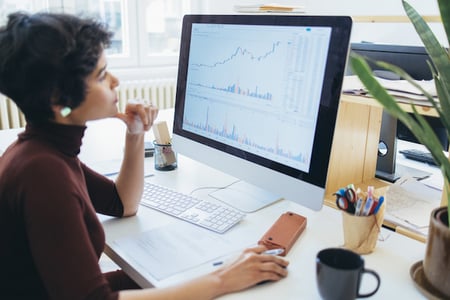 Business owner viewing customer loyalty analytics on a computer
