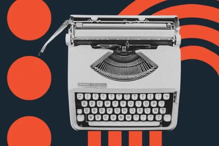 image shows a typewriter against a navy blue background 