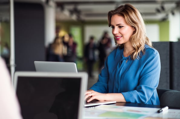 Female marketer creating an event invitation email.