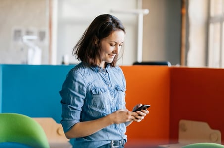 marketer using a mobile phone to post on instagram