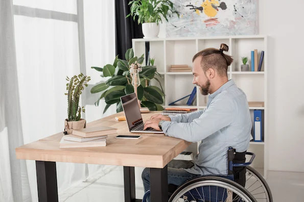 person using a laptop computer to choose a wordpress theme in his home office