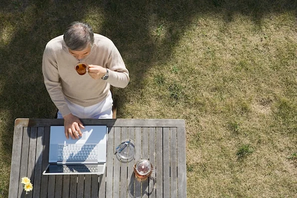 person sitting outside using a computer to customize a wordpress theme