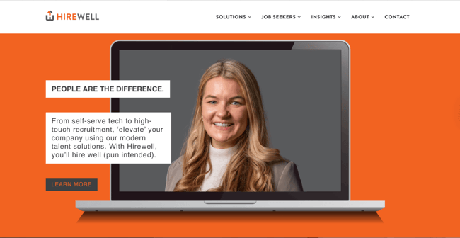 Hirewell recruitment website design with a bold orange hero and a recruiter photo framed inside a laptop mockup