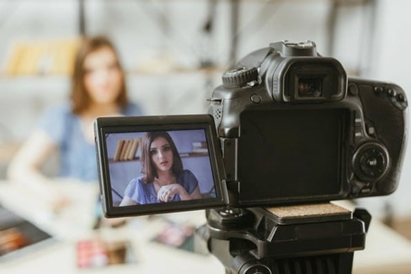 A person films a live video for their social media audience.