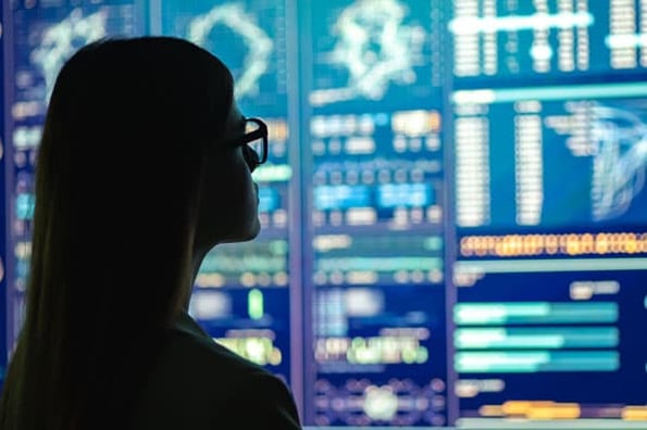 A marketer stares at a digital performance chart powered by marketing AI algorithms.