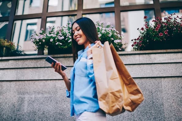 Millennial shopper researches products on smart phone