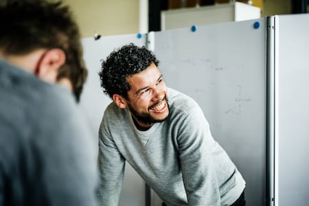 Sales rep smiling and in a good mood in meeting.