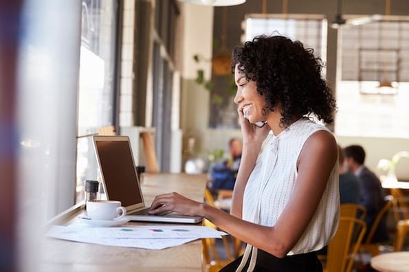 woman on the phone onboarding a new client 