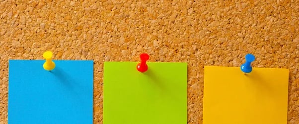 sticky notes on a cork board symbolizing the Pin It Generator tool