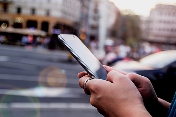 woman using mobile device for posting on instagram using step by step guide