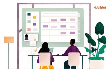 Two team members collaborating at a desk with a contact management interface displayed on screen