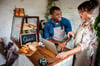 Small business owners in a bread shop researching new small business ideas on their laptop