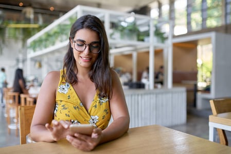 woman looking at her smartphone in the office