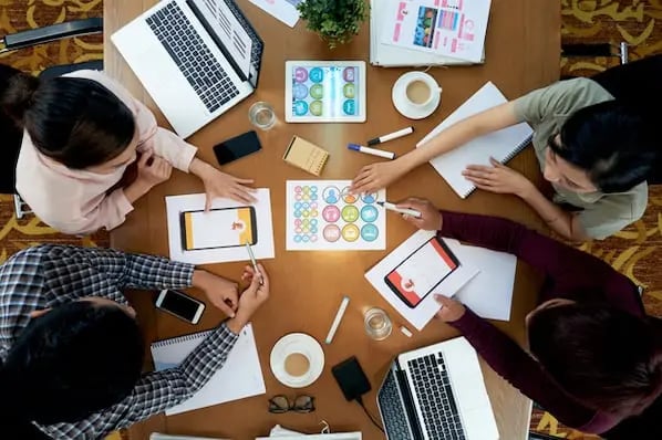 A project manager meets with colleagues to plan social projects or campaigns.