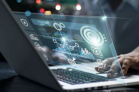 Web traffic, conversion and lead performance data for a business overlayed over a laptop