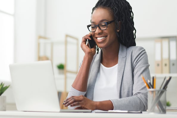 Marketer talking on the phone with her team and personalizing her website