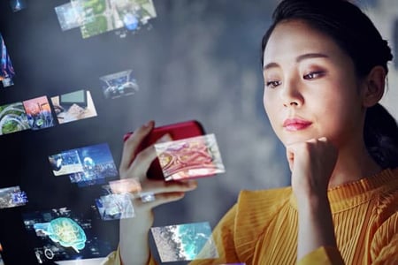 A woman visits YouTube and watches videos on her smartphone.