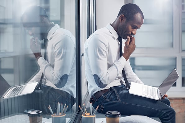 businessperson using computer to look for a wordpress security scan plugin tool