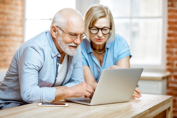 two people using a laptop to install wordpress multisite plugins