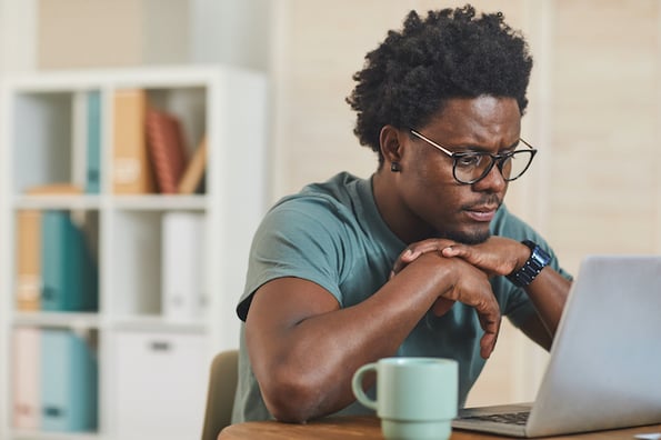 man using a laptop to speed up a WordPress Site