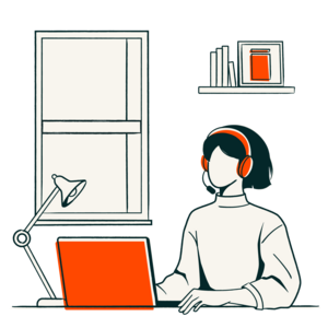 A woman sits in front of a laptop at her desk.