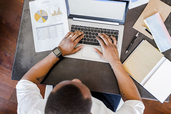 Mann führt Varianzanalyse (ANOVA) am Laptop durch