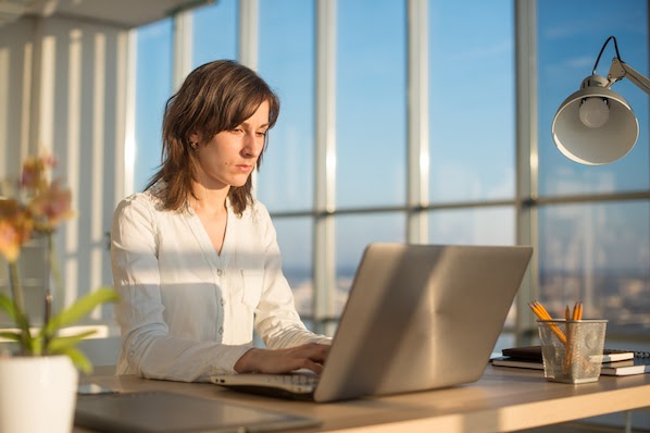 person using a laptop to nest CSS code