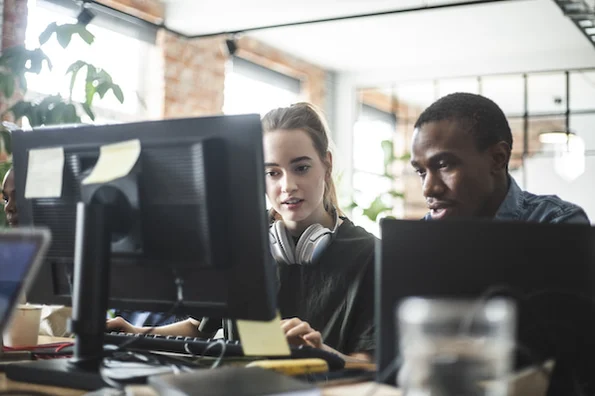 two developers measuring API response time on a computer
