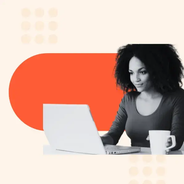 A woman smiles at her laptop