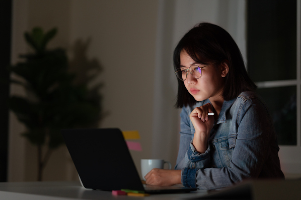 woman installing ecommerce plugin for wordpress on laptop