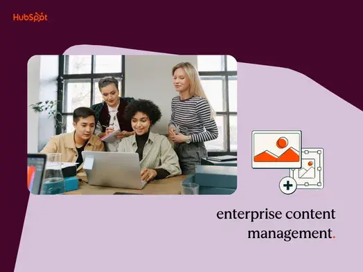 enterprise content management: four coworkers gathered around a laptop