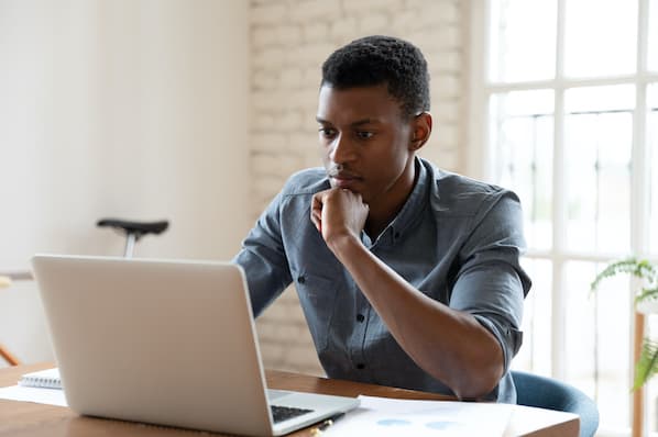 LinkedIn user sits in front of computer to add hashtags to a new article