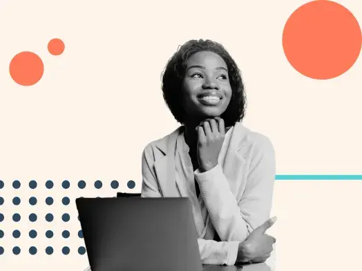 A woman smiles at her laptop