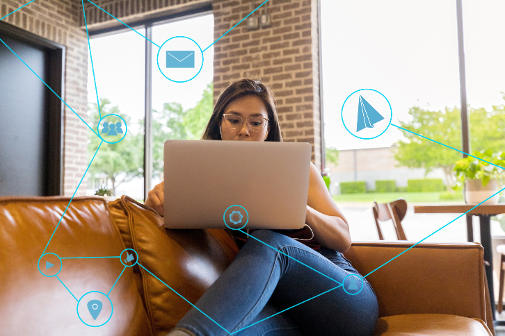 mulher sentada com laptop no colo pesquisa sobre como ganhar clientes nas redes sociais 