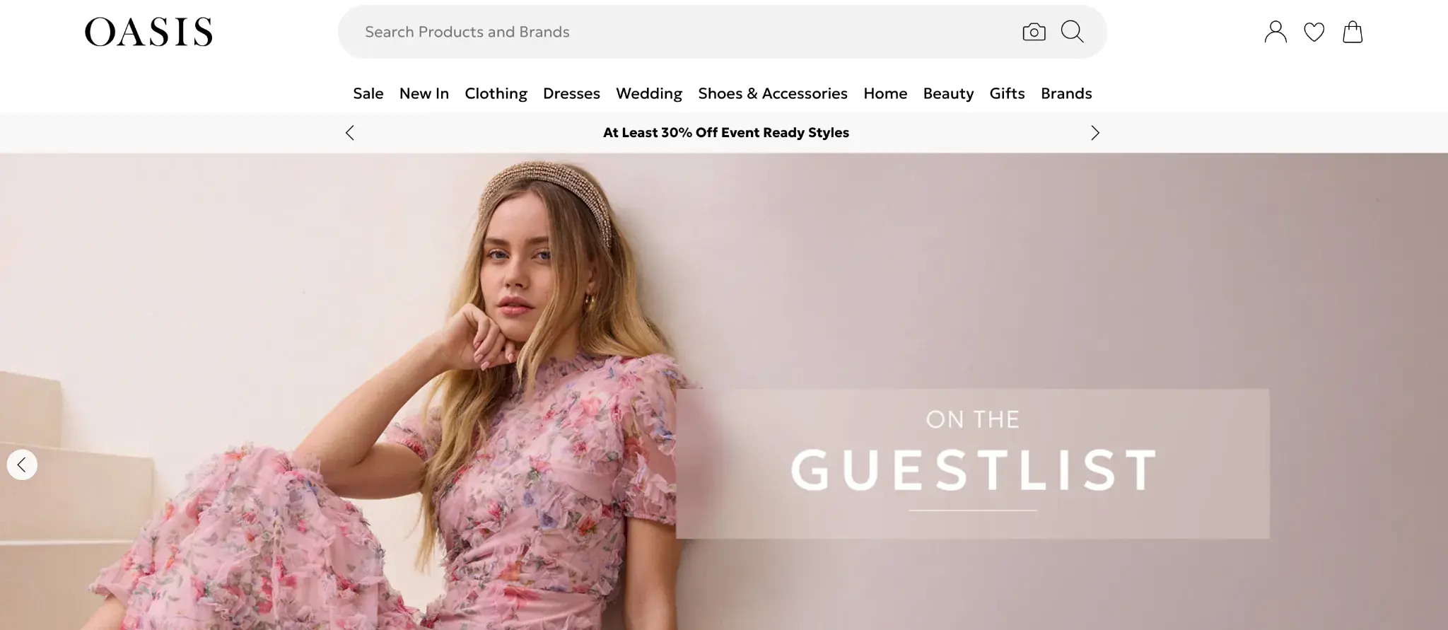Oasis fashion retailer website displaying navigation menu, search bar, and model wearing pink textured dress with ‘On the guestlist’ text