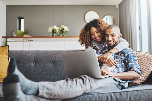 a couple browsing premium wordpress themes on a laptop