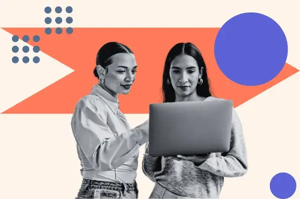 Two women look at SEO web design on a laptop