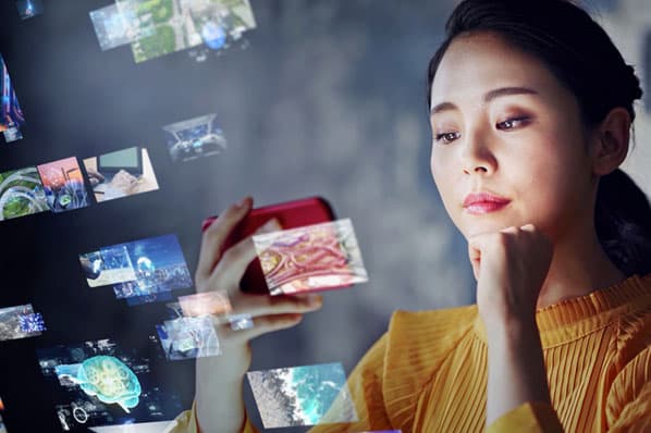A woman visits YouTube and watches videos on her smartphone.