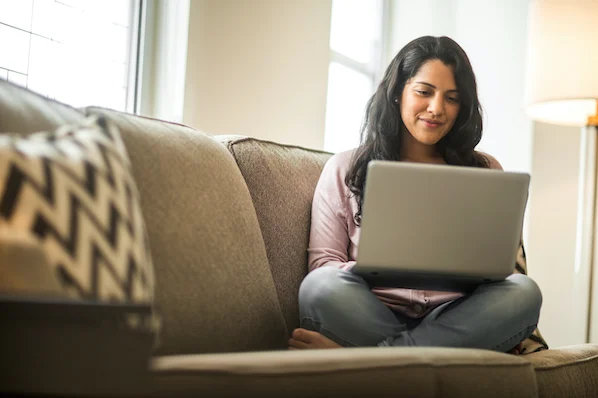 woman using a laptop computer to install a wordpress heatmap plugin on her website